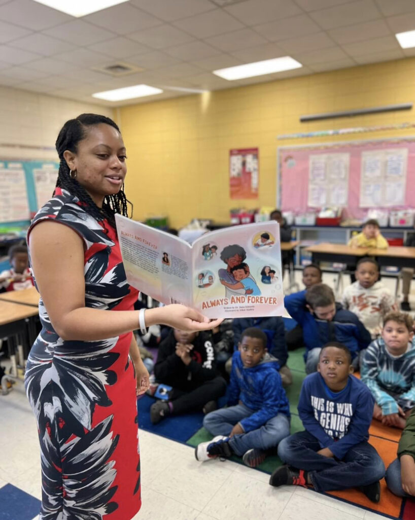 Dr. Dana Edwards reading her children’s book to elementary school students during an engaging classroom author visit.