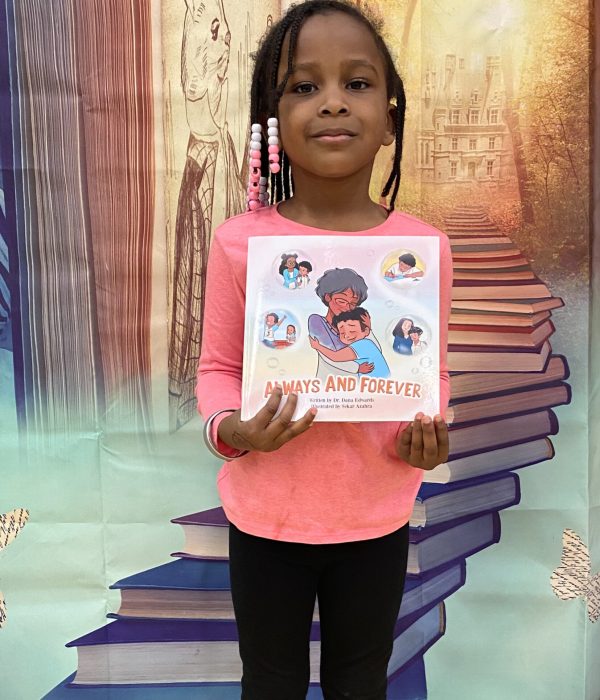 Young Reader holding Always and Forever book