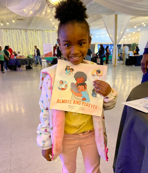Young Reader holding Always and Forever book